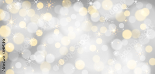 Silver bokeh background. Christmas glowing silver and golden lights with sparkles. Holiday decorative effect.