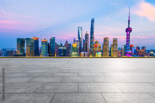 Empty square floor and modern cityscape in Shanghai at night.