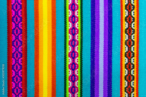 Vibrant colors of a traditional Andes textile on the local art and craft market of Cusco, Peru. Textiles are found in the Andes countries of Bolivia, Ecuador and Peru.