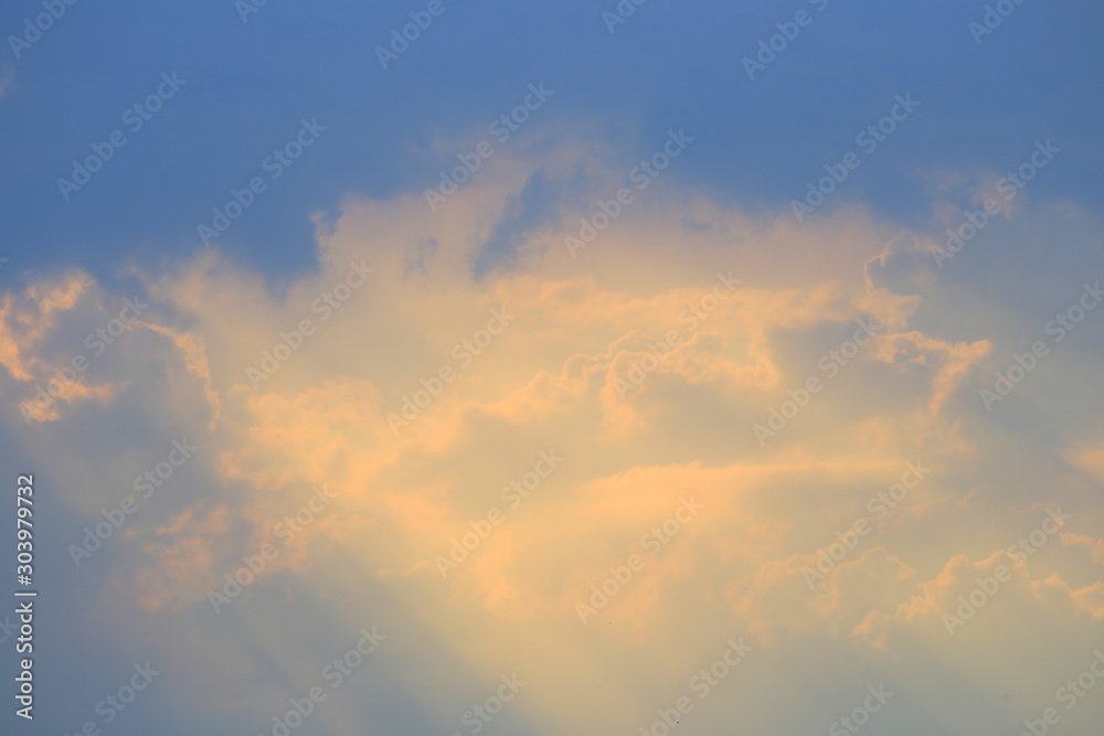 Yellow clouds at sunset on a blue sky
