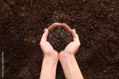 Female hands with brown soil