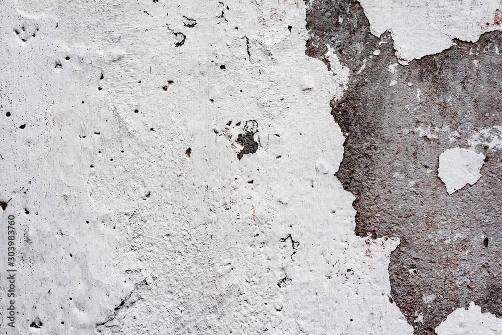 Texture of a concrete wall with cracks and scratches which can be used as a background Texture of a concrete wall with cracks and scratches which can be used as a background