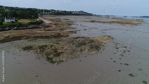 Aerial view. Flying over agrounded boats at low tide in English channel near Brittany coast. A small sailing yachts lying on the muddy bottom of the sea at low tide. photo