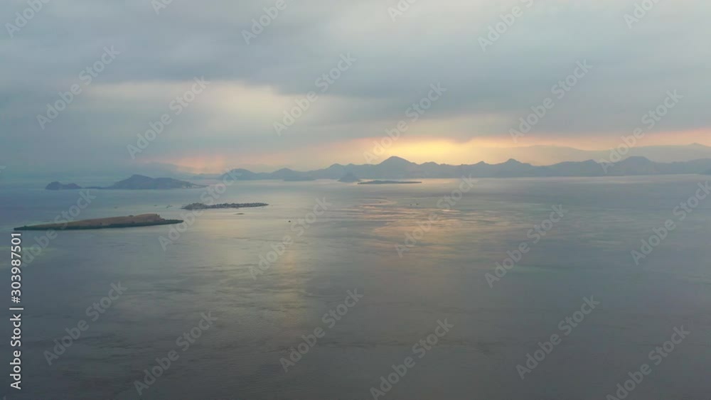 Dawn breaks over the calm seas surrounding islands within Komodo National Park, Indonesia. This area is known for its extraordinary marine biodiversity as well as its infamous Komodo dragons. Dawn breaks over the calm seas surrounding islands within Komodo National Park, Indonesia. This area is known for its extraordinary marine biodiversity as well as its infamous Komodo dragons.