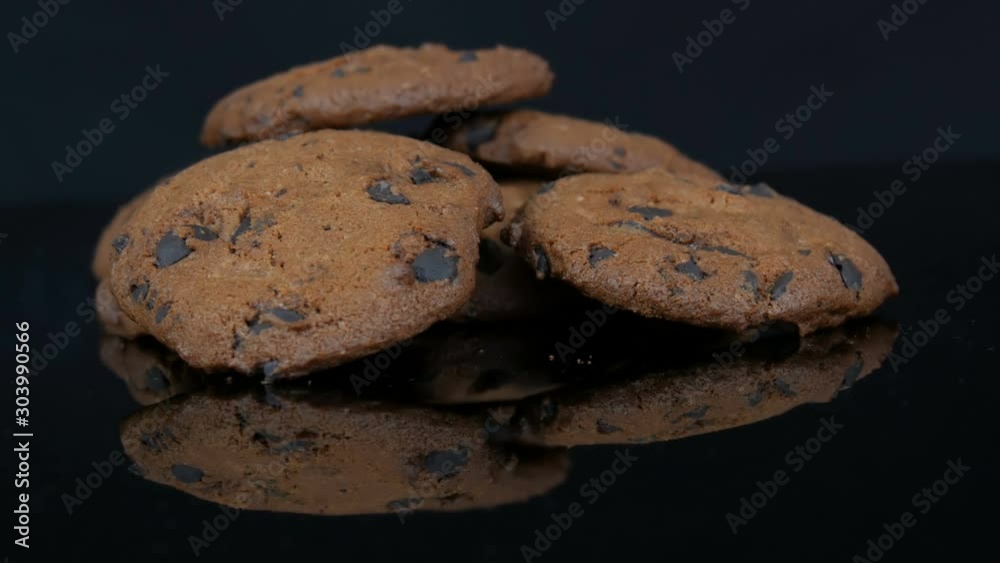 Chocolate cookies on a stylish black background and a mirror surface Chocolate cookies on a stylish black background and a mirror surface