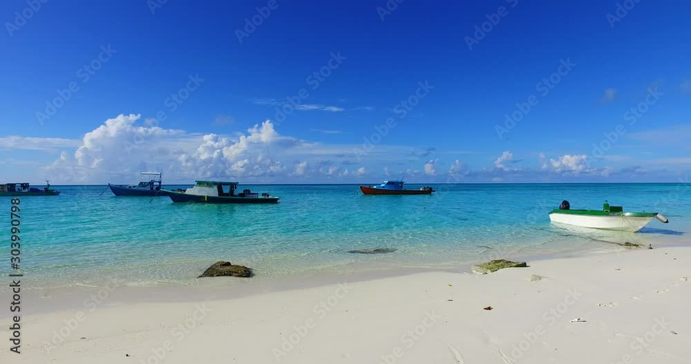 An Island In Samoa - Boats On The Clear Blue Waters Under The Blue Sky With Fluffy White Clouds In The Background - Wide Shot An Island In Samoa - Boats On The Clear Blue Waters Under The Blue Sky With Fluffy White Clouds In The Background - Wide Shot
