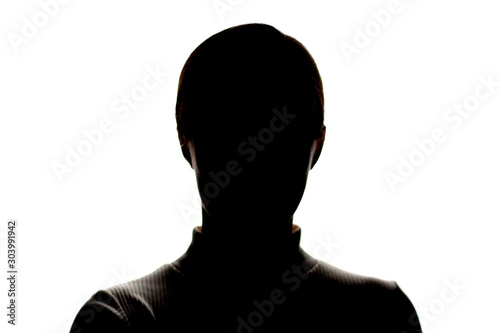 Dark silhouette of a young girl on white background, front view, concept of anonymity photo