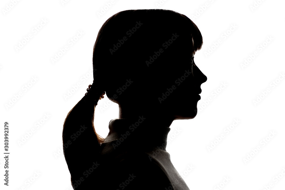 Dark silhouette profile of a young girl on white background, side view