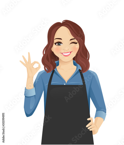 Smiling woman in apron gesturing ok sign isolated vector illustration