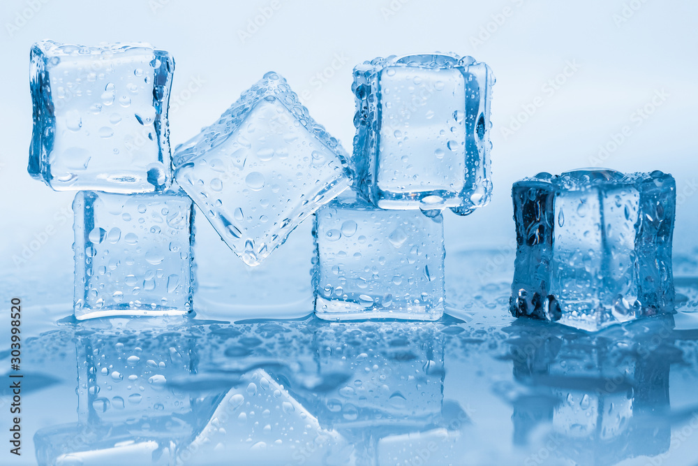 Ice cubes square with drops water clean on blue background
