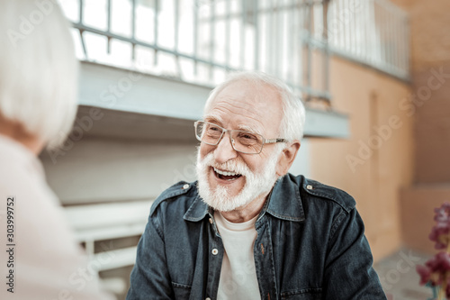 Joyful bearded aged man feeling absolutely happy