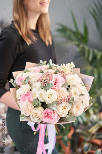 Wallpaper Mural European floral shop. Beautiful bouquet of mixed flowers in womans hands. the work of the florist at a flower shop. Delivery fresh cut flower. Torontodigital.ca