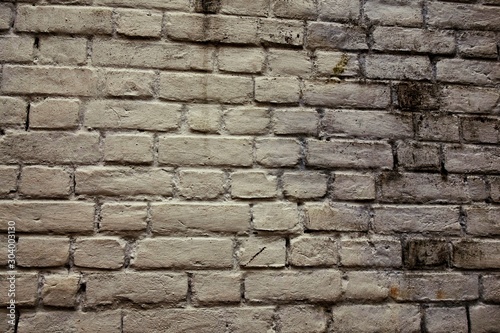 Beige colour bricks wall with symmetrical pattern.