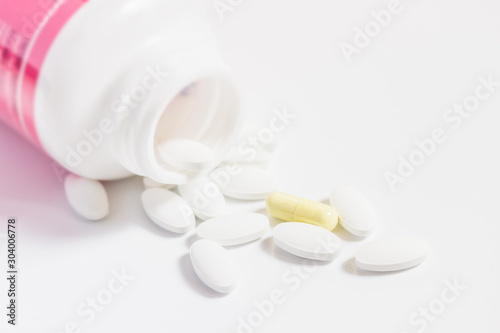 pills and bottle on white background