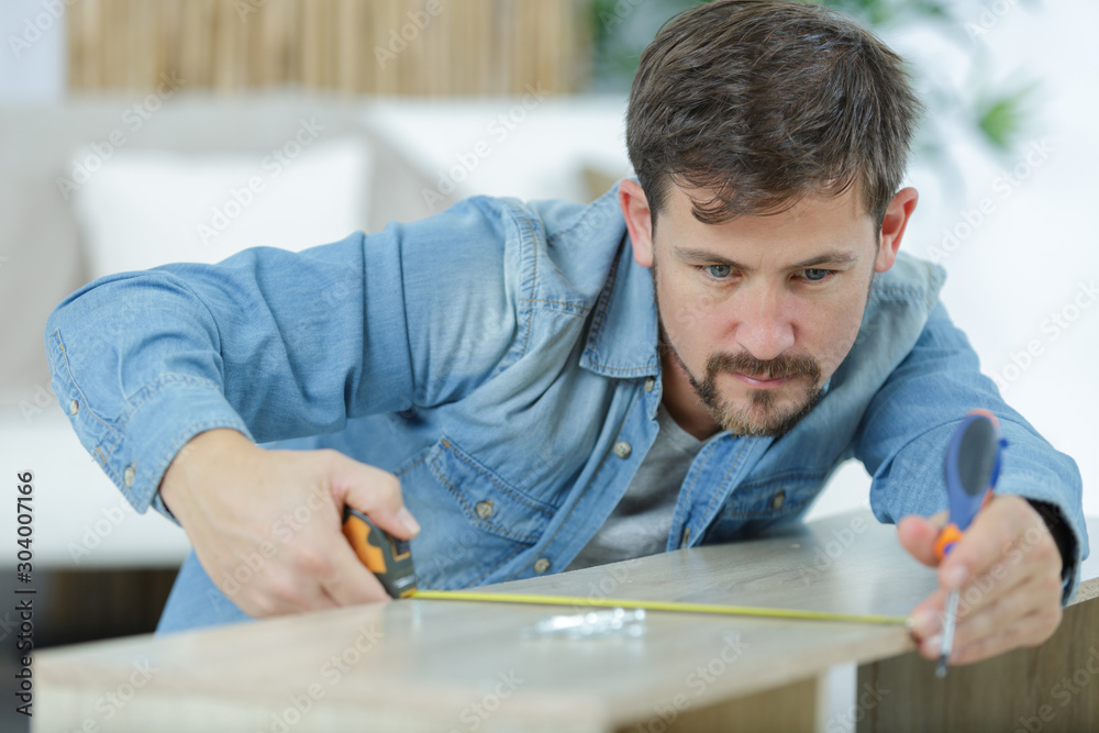 man assembling furniture man assembling furniture
