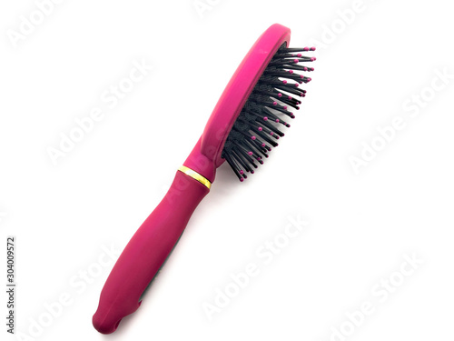 Pink comb isolated on a white background. Female hairbrush. Professional hairbrush.