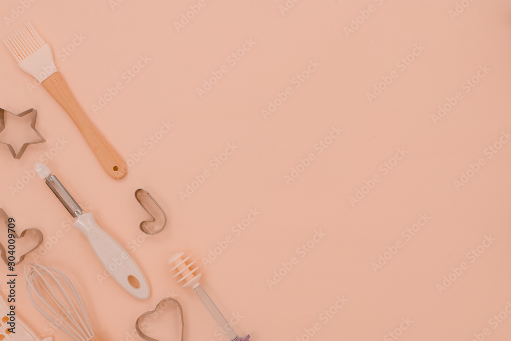 Various pink kitchen utensils on abstract pink background. Greater, whisk and iron cooking form. Top horizontal view copyspace love cookong concept Various pink kitchen utensils on abstract pink background. Greater, whisk and iron cooking form. Top horizontal view copyspace love cookong concept