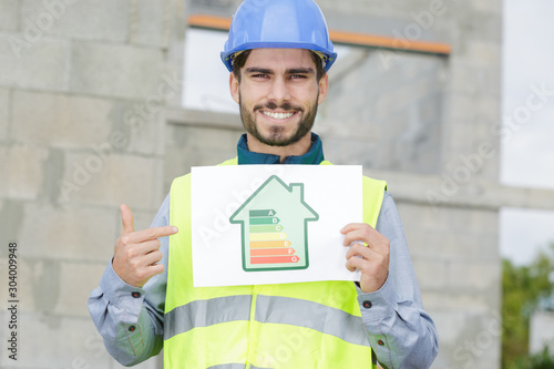 laborer showing energy rating sign photo