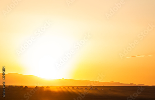 Sonnenaufgang auf der Songköl Hochebene in Kirgistan über einem Jurtcamp photo