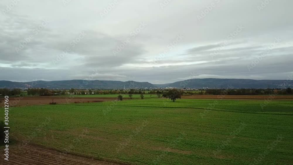 Slowly rising over green farm land with mountains in background, Odenwald Germany. Slowly rising over green farm land with mountains in background, Odenwald Germany.