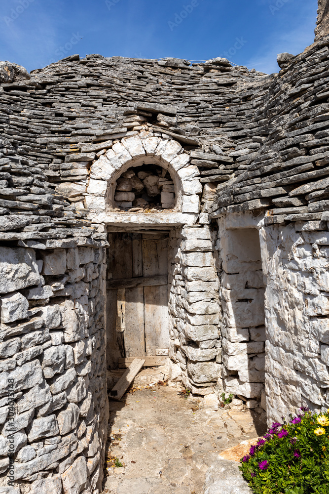 Trulli village in Alberobello, Italy. The style of construction is specific to the Murge area of the Italian region of Apulia (in Italian Puglia). Made of limestone and keystone.