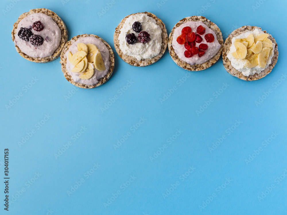 Sweets made of crispy bread and fruit on a blue background. There is room for text at the bottom Sweets made of crispy bread and fruit on a blue background. There is room for text at the bottom