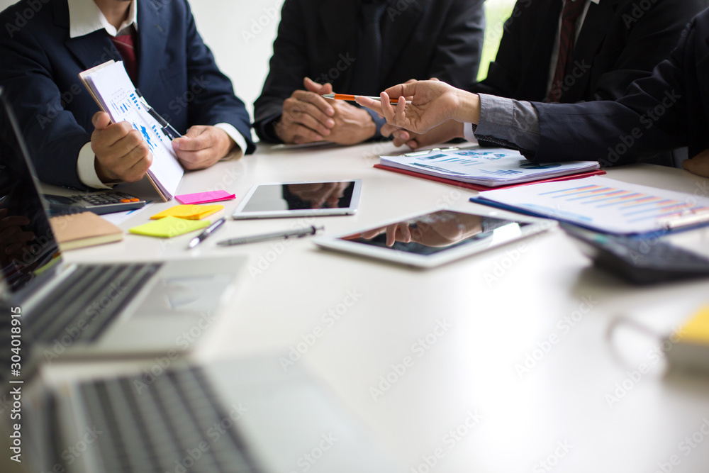 Business group or business partners discussing documents and ideas at meeting Business group or business partners discussing documents and ideas at meeting