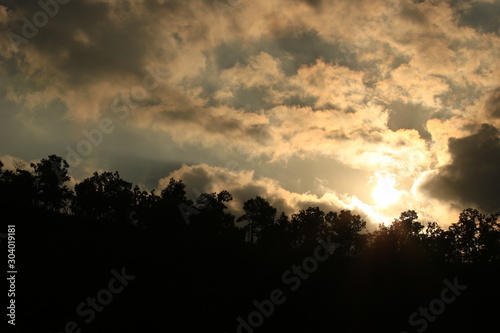 Sunset landscape view of silhouette mountains with sky and clouds and sun,twilight sky and clouds with evening sunset background,Beautiful scene of nature