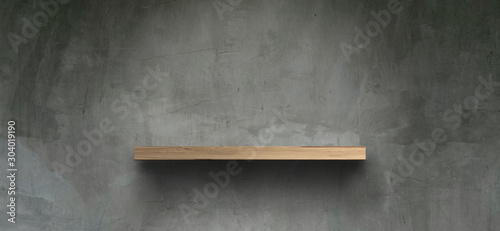 Empty wooden shelves on the floor, bare concrete walls For placing products Or product