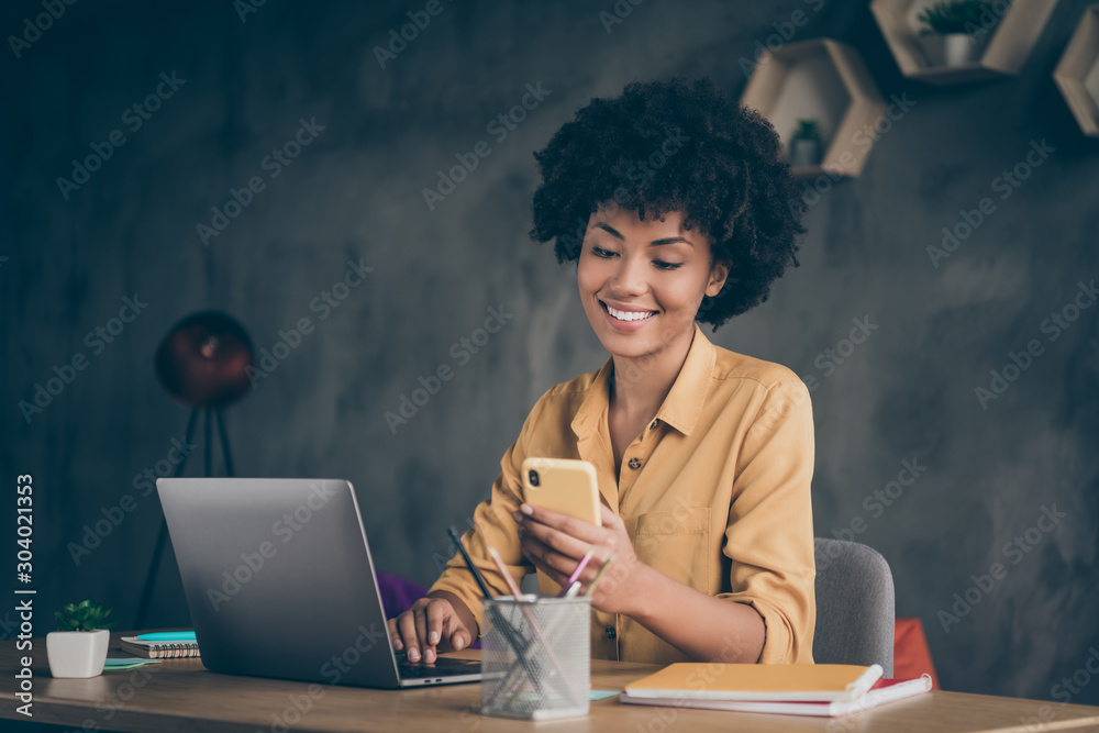 Photo of cheerful positive entrepreneur smiling toothily seeing message from her boss praising her about project finished and startup realized - obrazy, fototapety, plakaty 