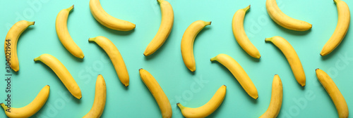 Many sweet ripe bananas on color background photo