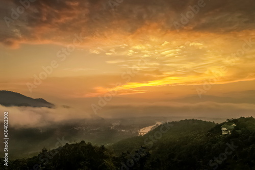Mountain view misty morning above Kok river and Tha Ton city in valley around with sea of mist with cloudy sky background  sunrise at Wat Tha Ton  Fang  Chiang Mai  northern of Thailand.