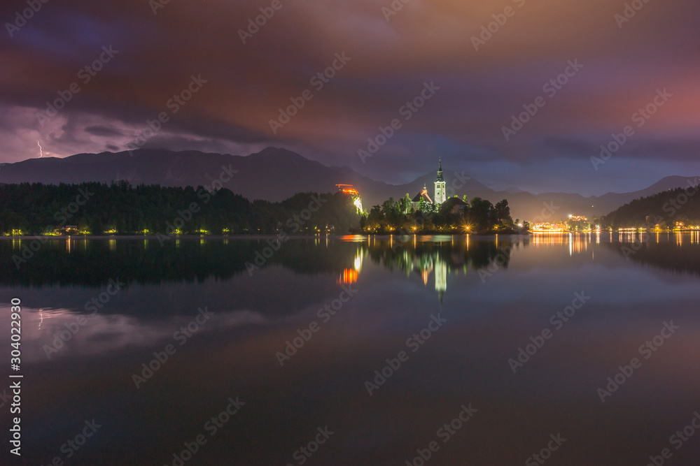Storm clouds over a church on an island on Lake Bled, Slovenia