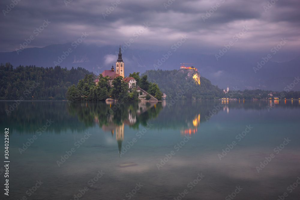 Storm clouds over a church on an island on Lake Bled, Slovenia