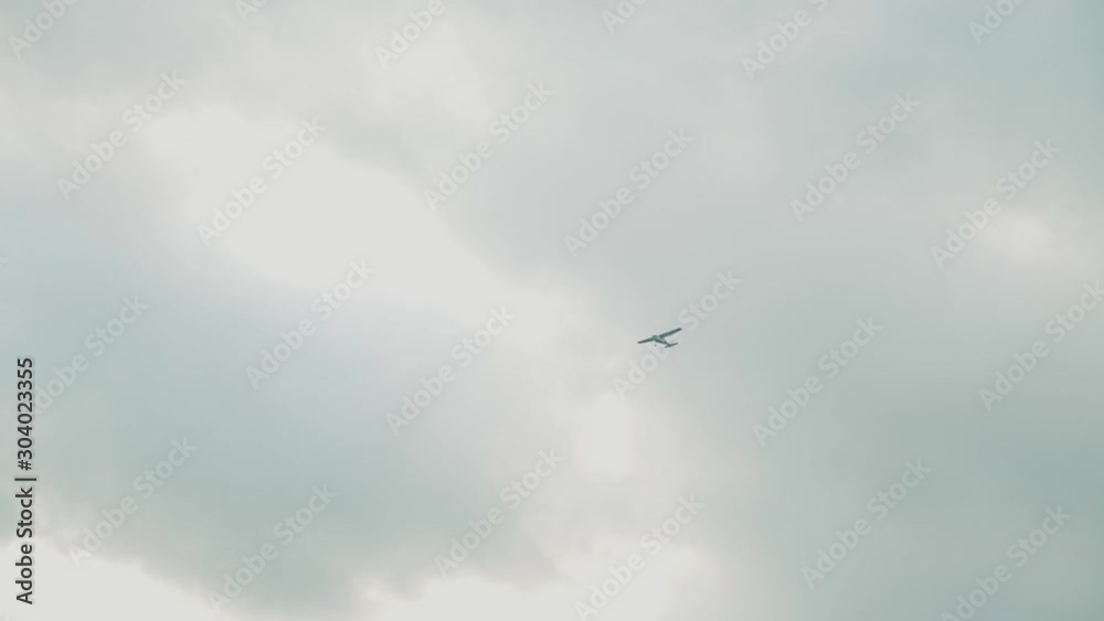Grey sky and a small jet crossing it Grey sky and a small jet crossing it