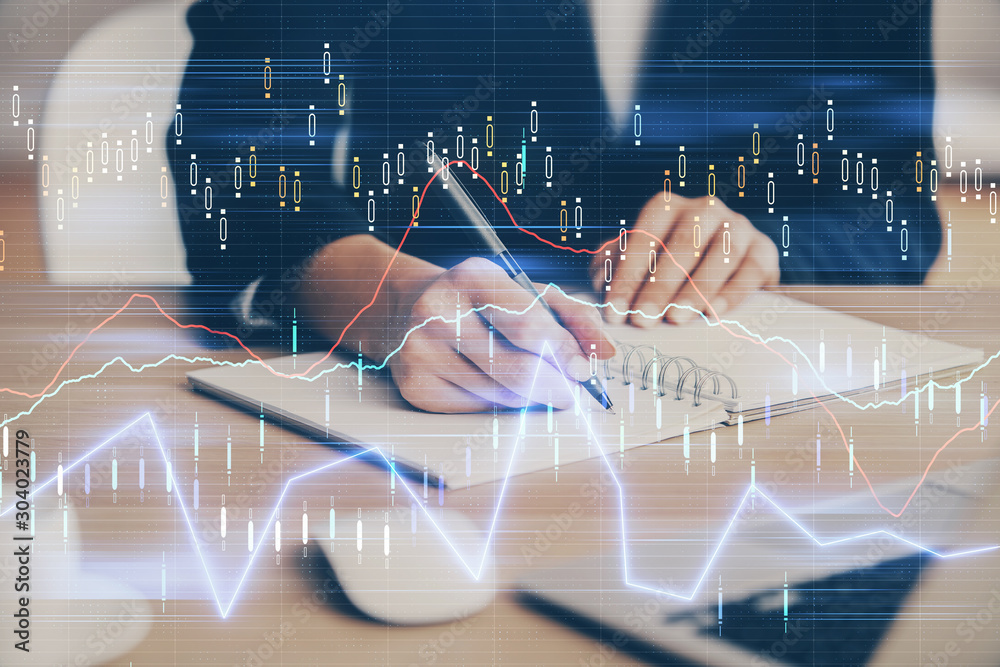 Forex graph on hand taking notes background. Concept of research. Multi exposure Forex graph on hand taking notes background. Concept of research. Multi exposure