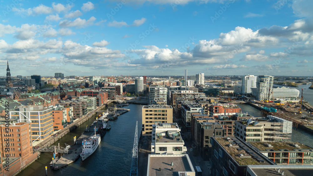 hafencity hamburg cityscape with many boats, modern houses and clouds, germany