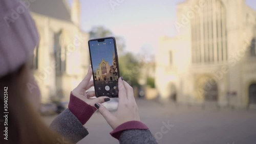 Traveler Woman Taking Picture of Norwich Cathedral, England. photo