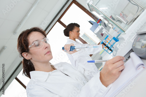 female working writing report in lab