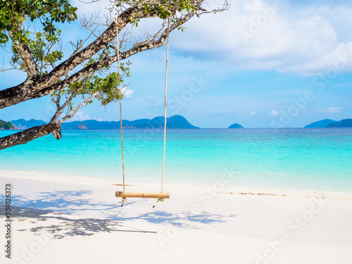 Rope and bamboo swing with white sand beach sea view background  Travel plans in holidays or after retirement