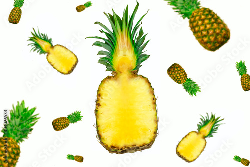 whole and half pineapples flying isolated on white background
