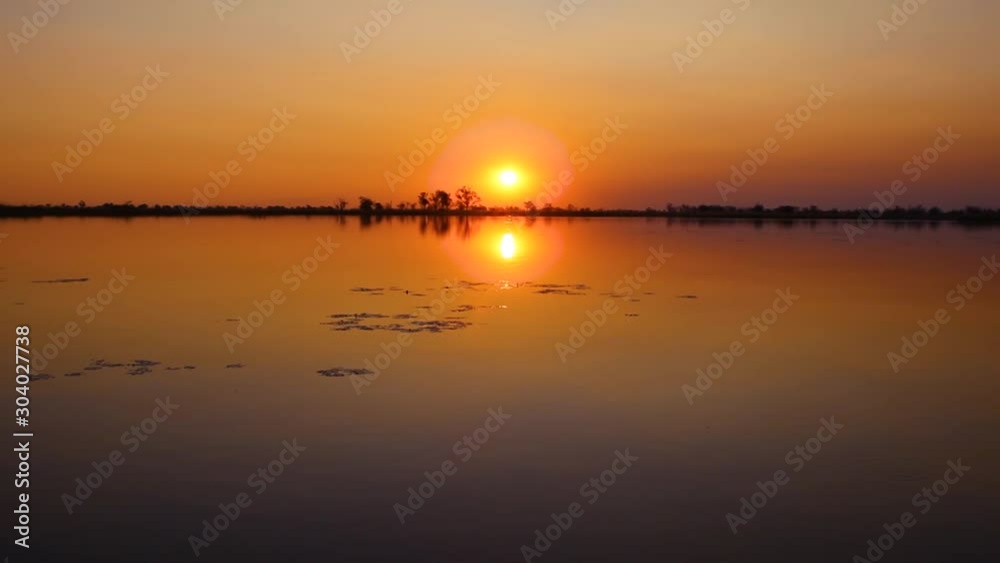 Sunset over a lake with the silhouette of trees in Botswana. Sunset over a lake with the silhouette of trees in Botswana.
