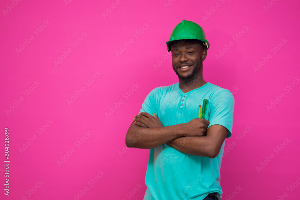 a young african engineer feels happy about his profession and holds a screwdriver a young african engineer feels happy about his profession and holds a screwdriver