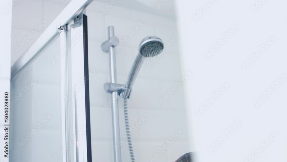 Water running from shower on washing person. Water splashing on head. Water running from shower on washing person. Water splashing on head.