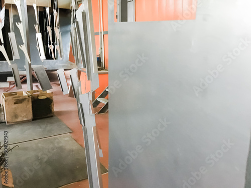 Powder coating line. Industrial interior. Workshop equipped with conveyors.