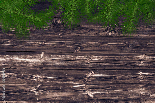 Christmas background for advertising or greetings. wooden background, spruce and glow.