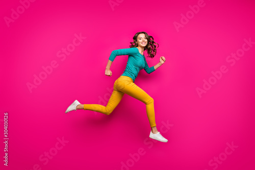 Fototapeta Naklejka Na Ścianę i Meble -  Full length body size side profile photo of cheerful positive cute nice girl running jumping curly wavy white footwear isolated pink vibrant color background