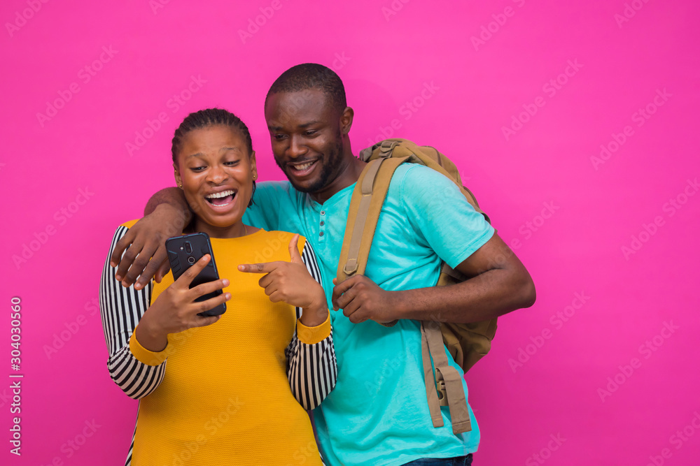 Obraz premium two africans got excited with what they saw on their cellphone