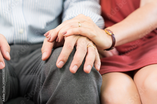 Fotografija Close up of hands of wife reaching out for husband's hands and holding to comfort him