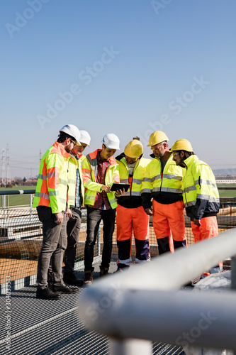 Wallpaper Mural Engineers and workers assesing wastewater plant Torontodigital.ca